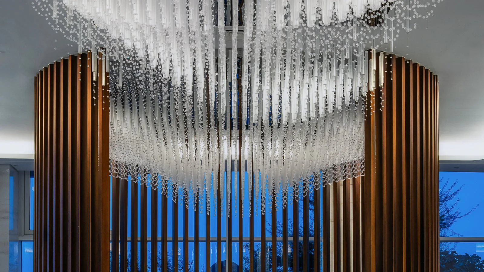 Hidd Al Saadiyat lobby with a sculptural chandelier and timber screen